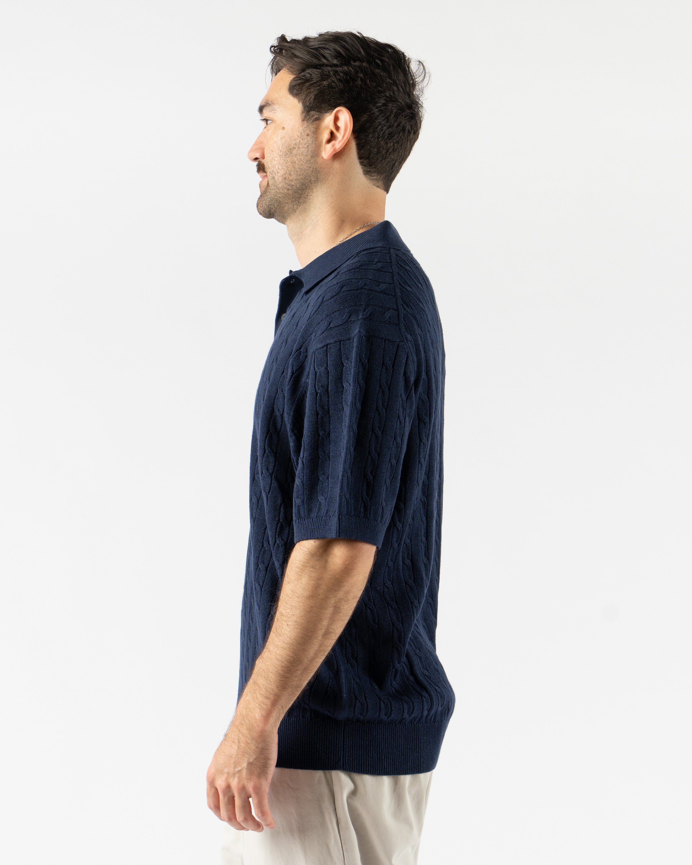 Beams Plus Cable Knit Polo in Navy – timeless men’s short sleeve polo with a textured cable knit pattern, crafted from soft cotton with a ribbed collar and tonal buttons for a refined, vintage-inspired style.