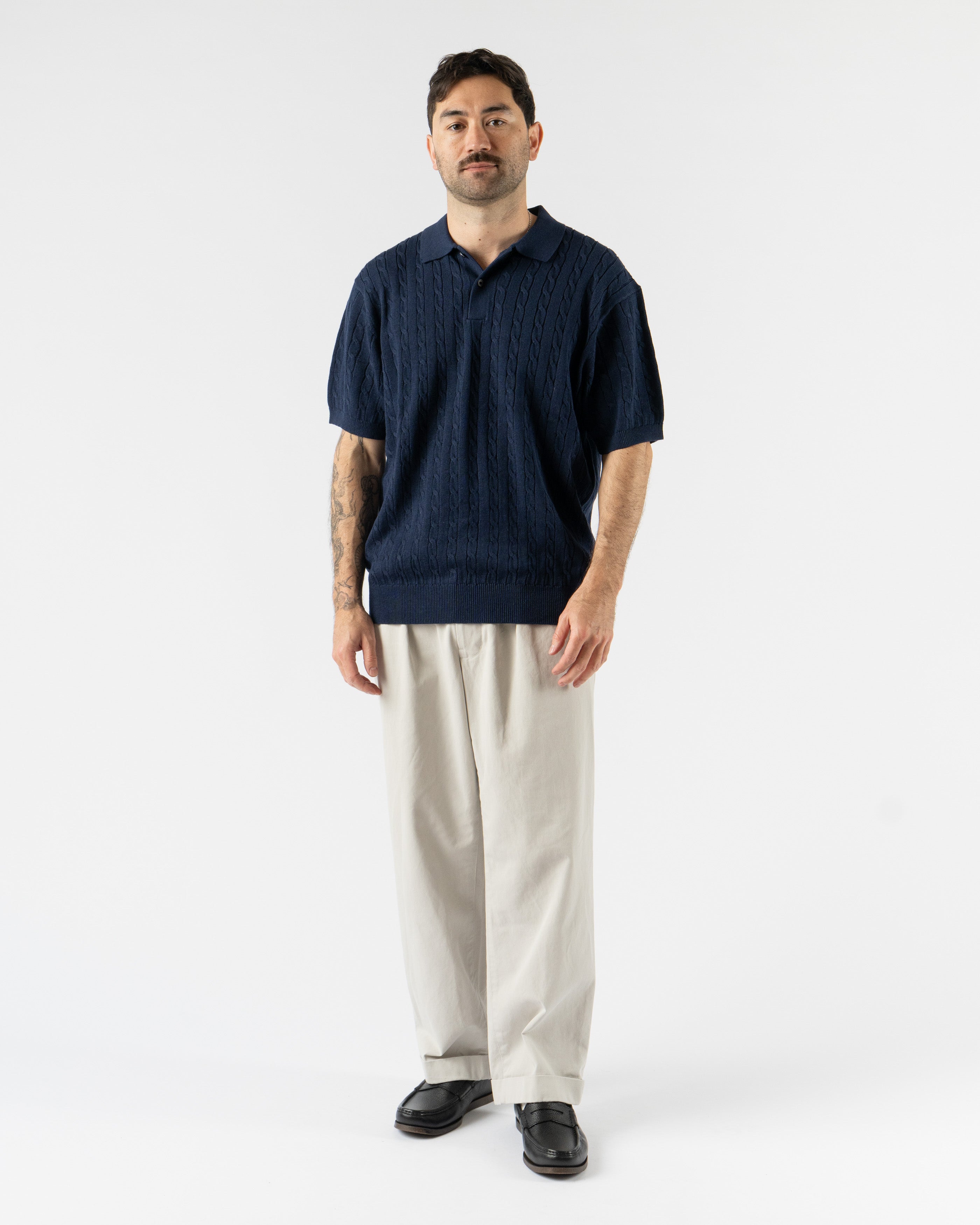 Beams Plus Cable Knit Polo in Navy – timeless men’s short sleeve polo with a textured cable knit pattern, crafted from soft cotton with a ribbed collar and tonal buttons for a refined, vintage-inspired style.