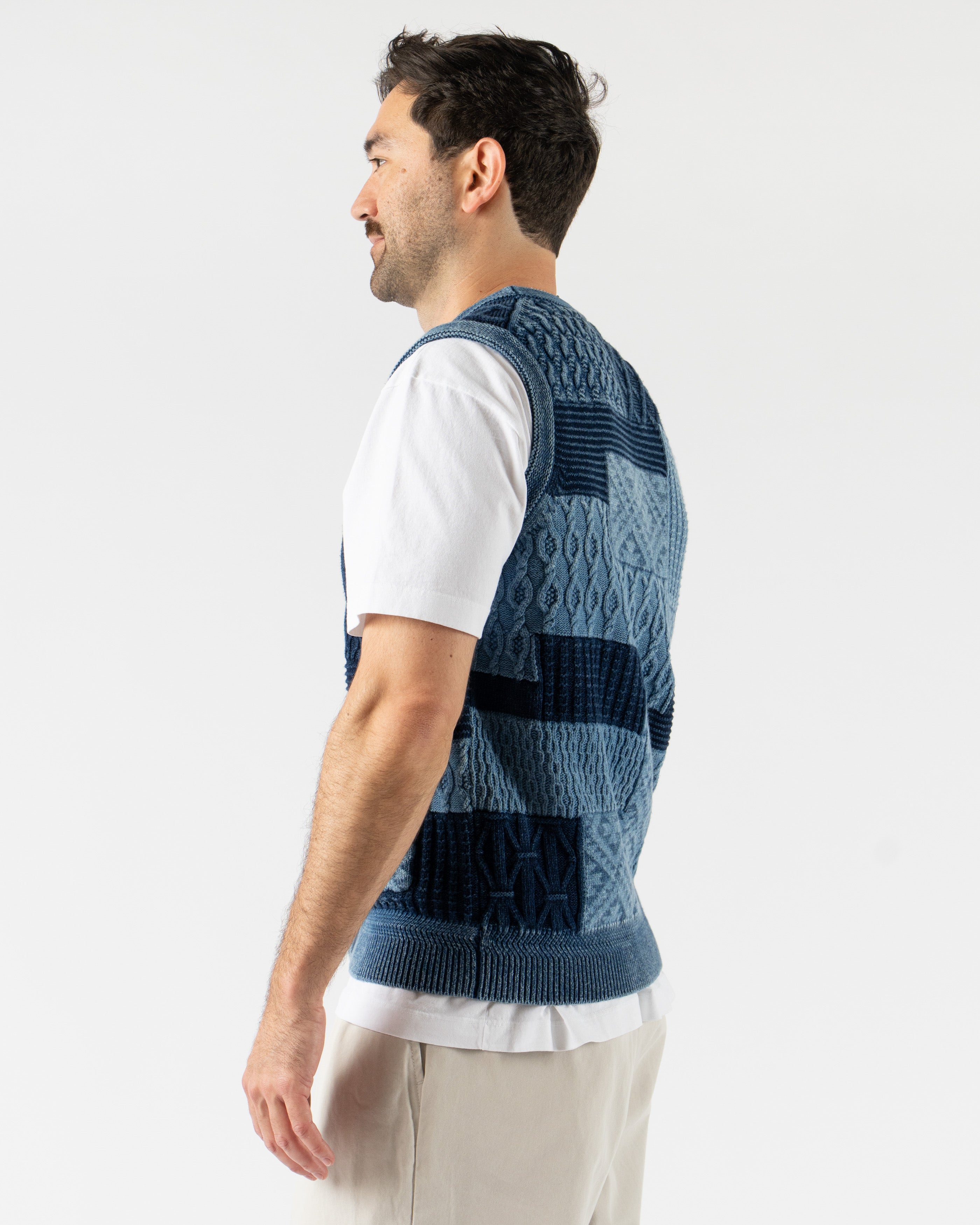 Beams Plus Patchwork Indigo Vest – heritage-inspired men’s vest crafted from a mix of indigo-dyed fabrics in a patchwork design, featuring a button-front closure, V-neckline, and multiple front pockets for a rugged, utilitarian look.