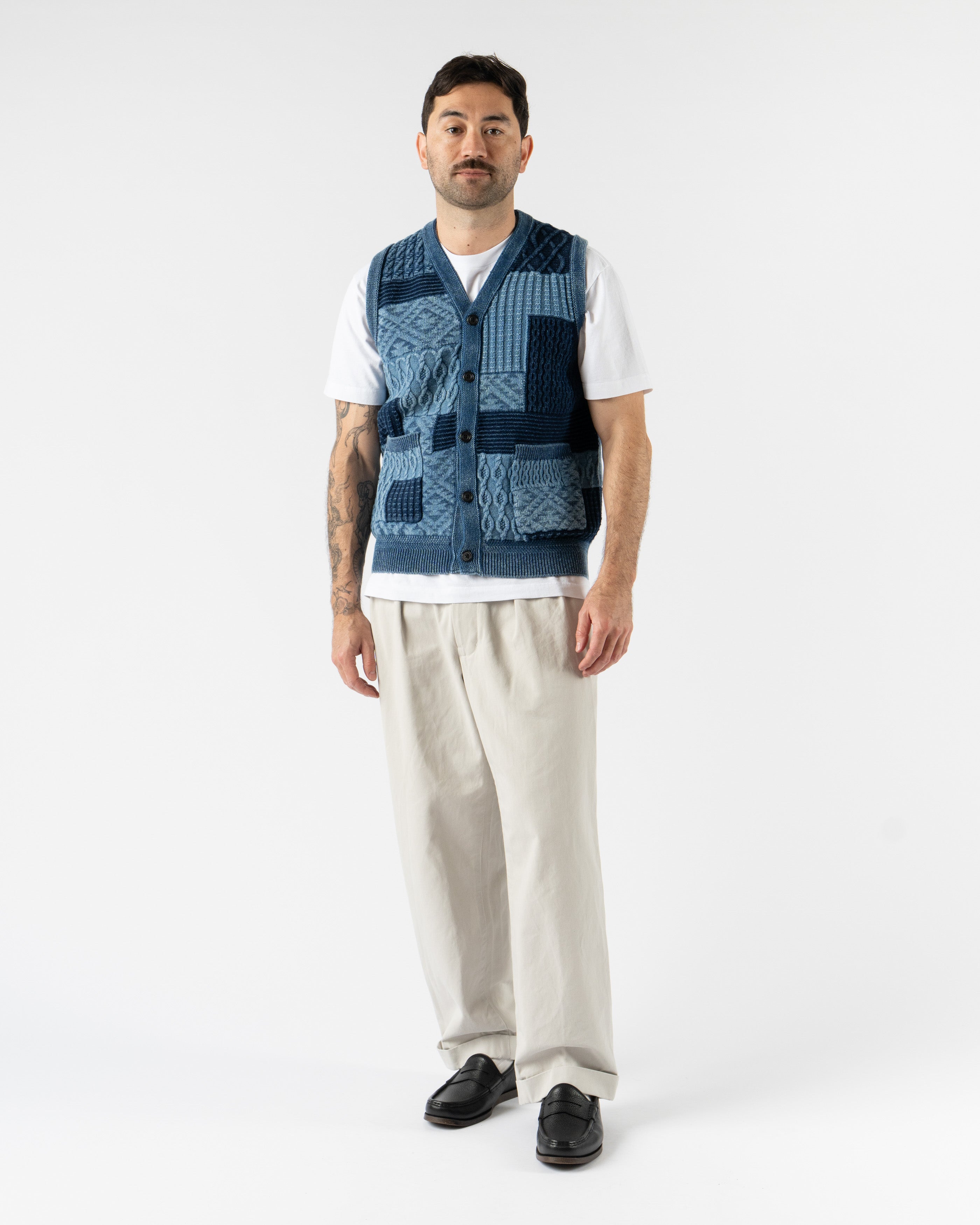 Beams Plus Patchwork Indigo Vest – heritage-inspired men’s vest crafted from a mix of indigo-dyed fabrics in a patchwork design, featuring a button-front closure, V-neckline, and multiple front pockets for a rugged, utilitarian look.