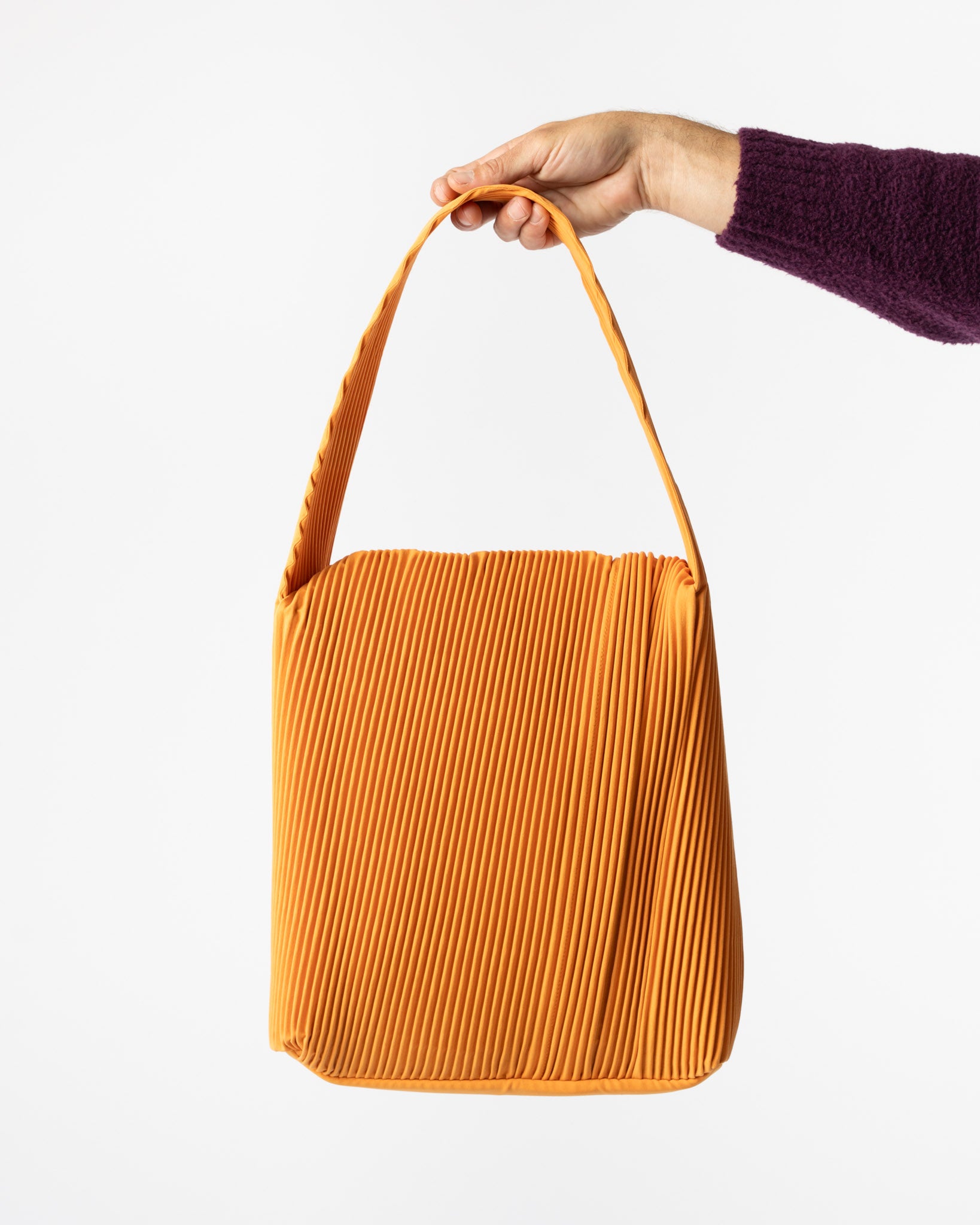 Homme Plissé Issey Miyake Rounded Square Bag in Orpiment Orange