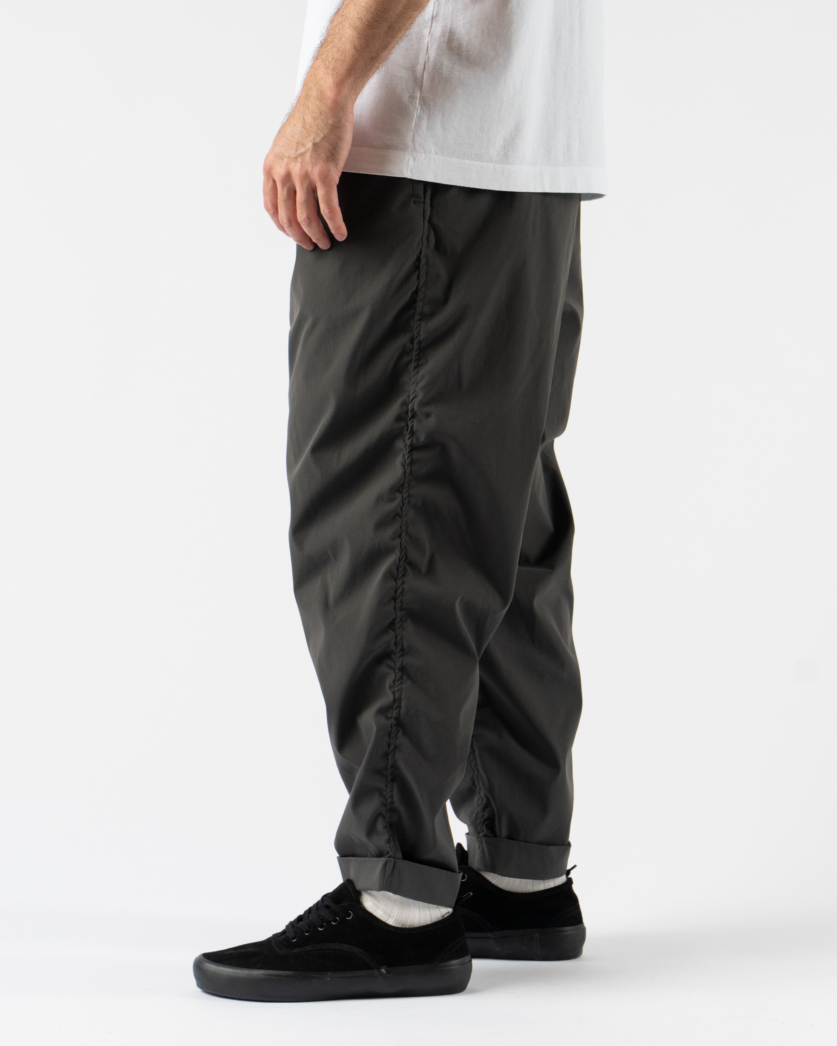 Pilgrim Surf + Supply Salathe Climbing Pant in Charcoal shown from multiple angles, crafted from recycled polyester with a relaxed, tapered fit, elastic waistband, and articulated knees. Featuring durable construction, minimal branding, and technical design details ideal for climbing, travel, or everyday wear in a versatile charcoal grey.