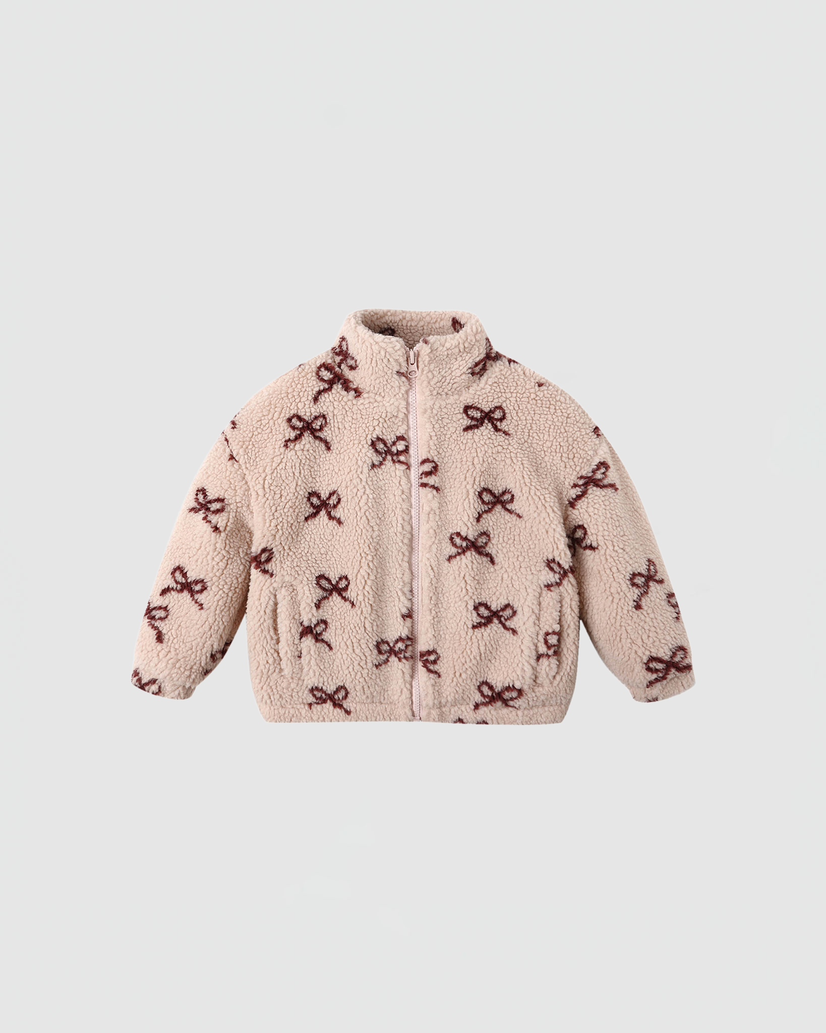 Pink jacket with bow pattern on a light gray background