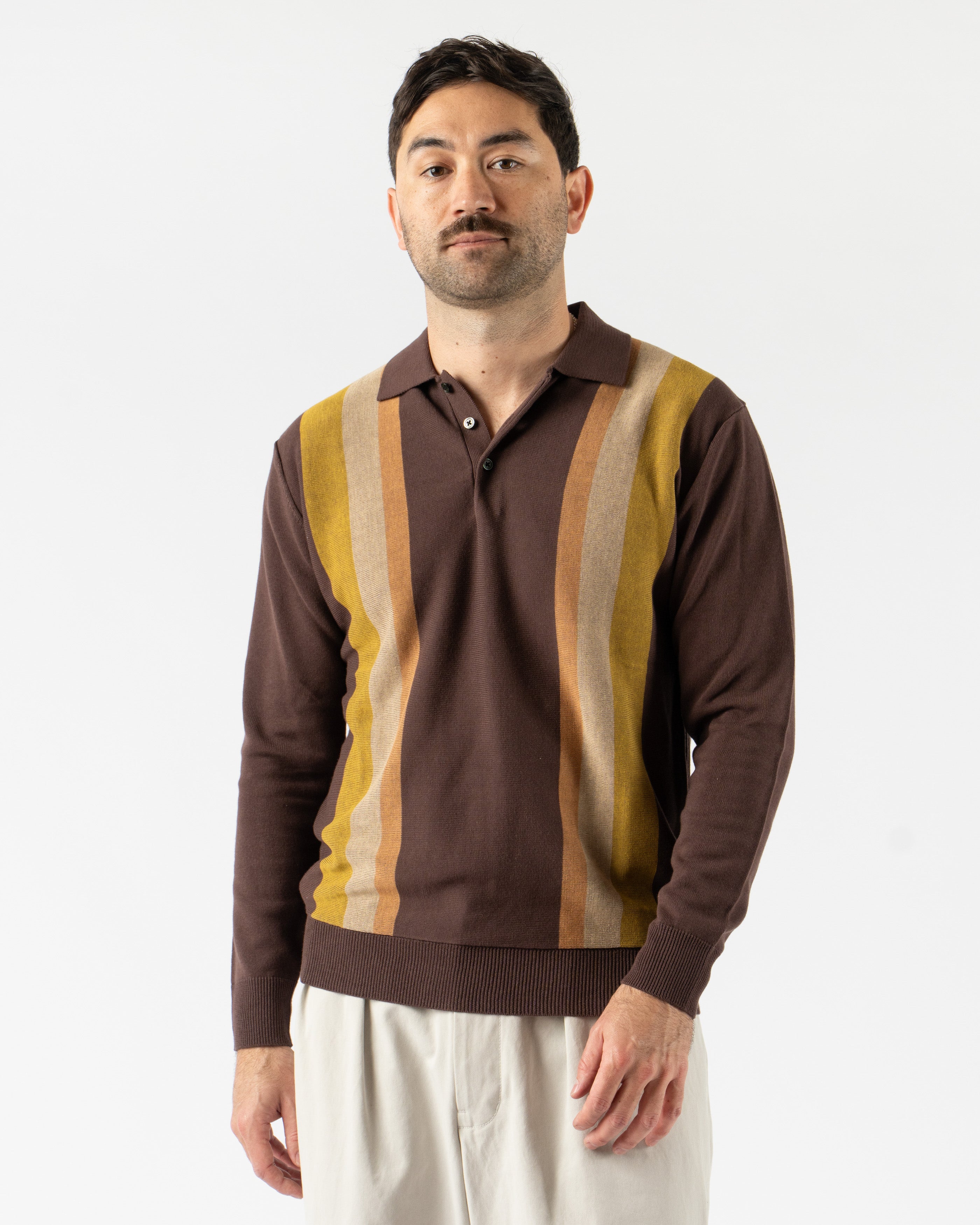  Beams Plus Argyle Knit Polo in Dark Brown Stripe – retro-inspired short sleeve polo featuring a bold argyle and stripe knit pattern, soft cotton construction, ribbed collar and cuffs, and a button-up placket for vintage charm with modern flair.