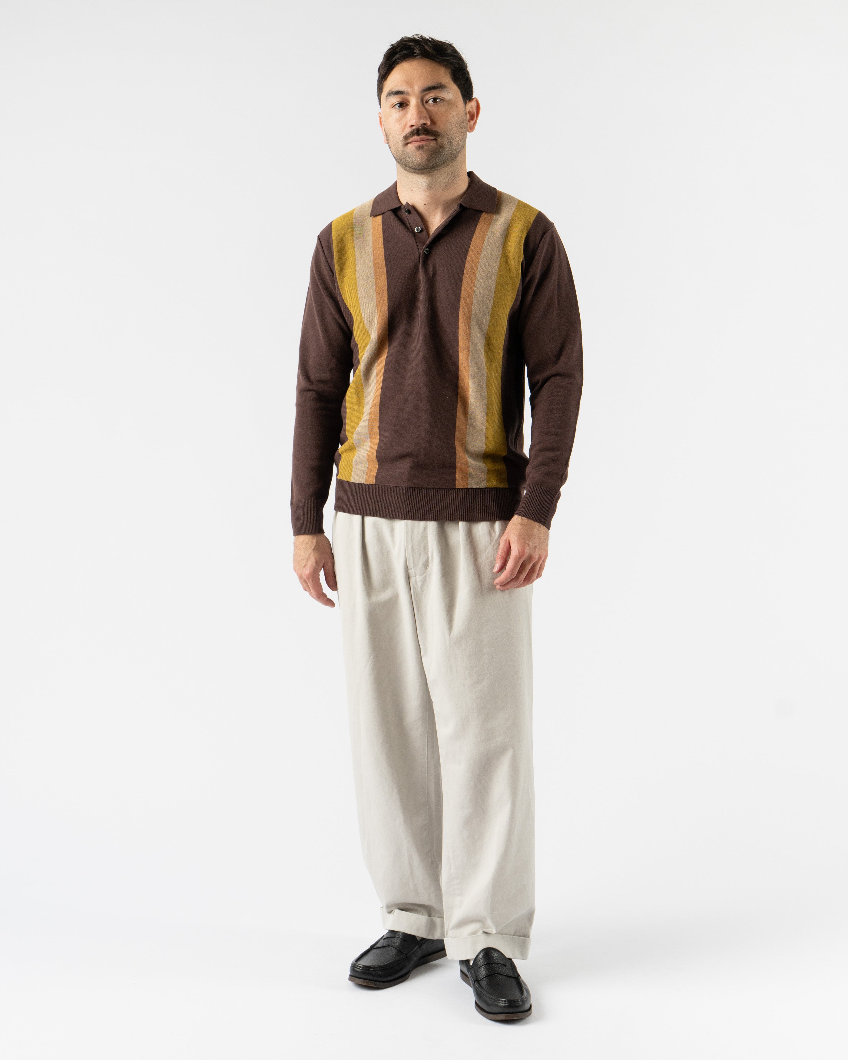  Beams Plus Argyle Knit Polo in Dark Brown Stripe – retro-inspired short sleeve polo featuring a bold argyle and stripe knit pattern, soft cotton construction, ribbed collar and cuffs, and a button-up placket for vintage charm with modern flair.