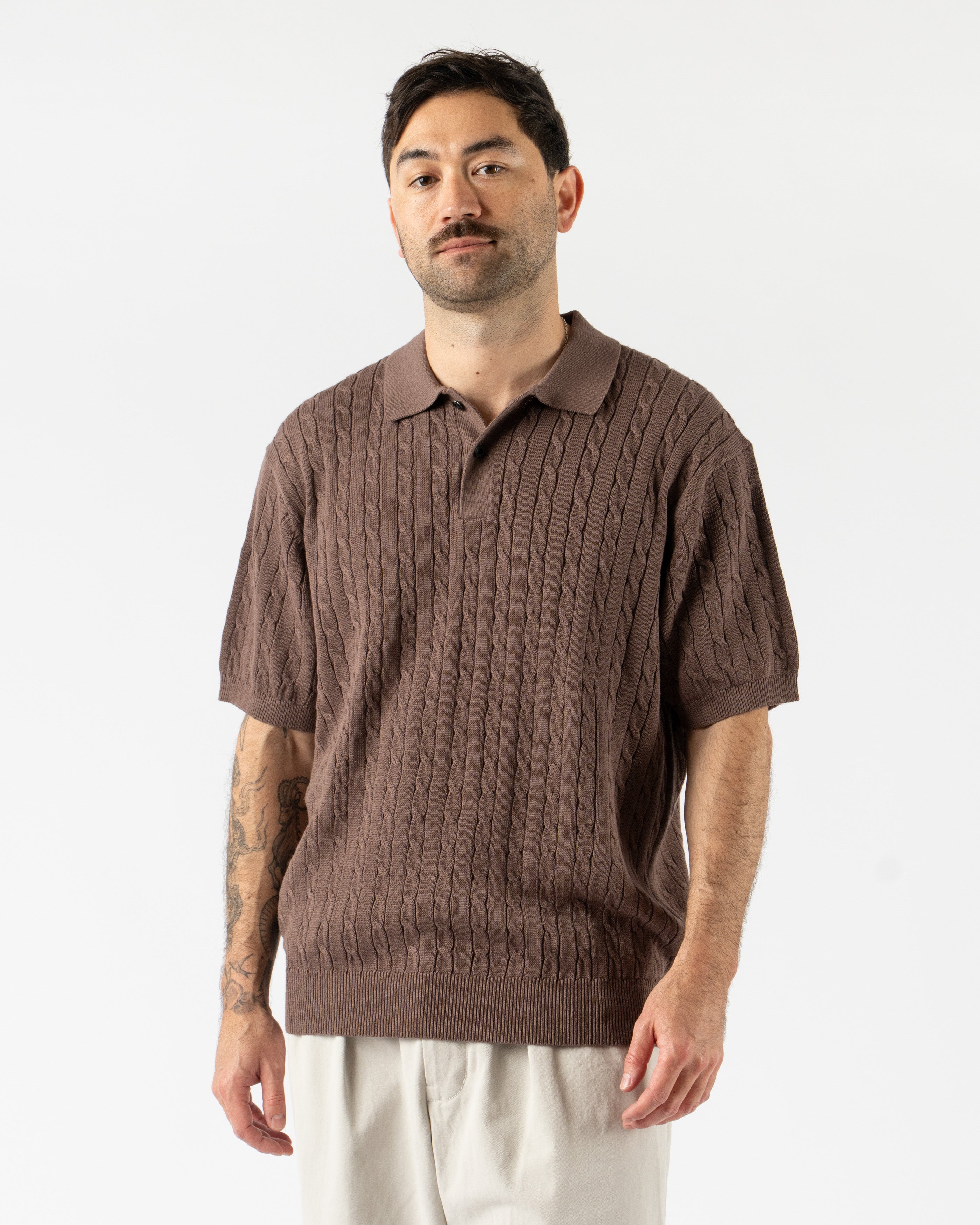 Beams Plus Cable Knit Polo in Brown – vintage-inspired short sleeve men’s polo featuring textured cable knit design, soft cotton construction, ribbed collar, and tonal buttons for a classic yet modern look.