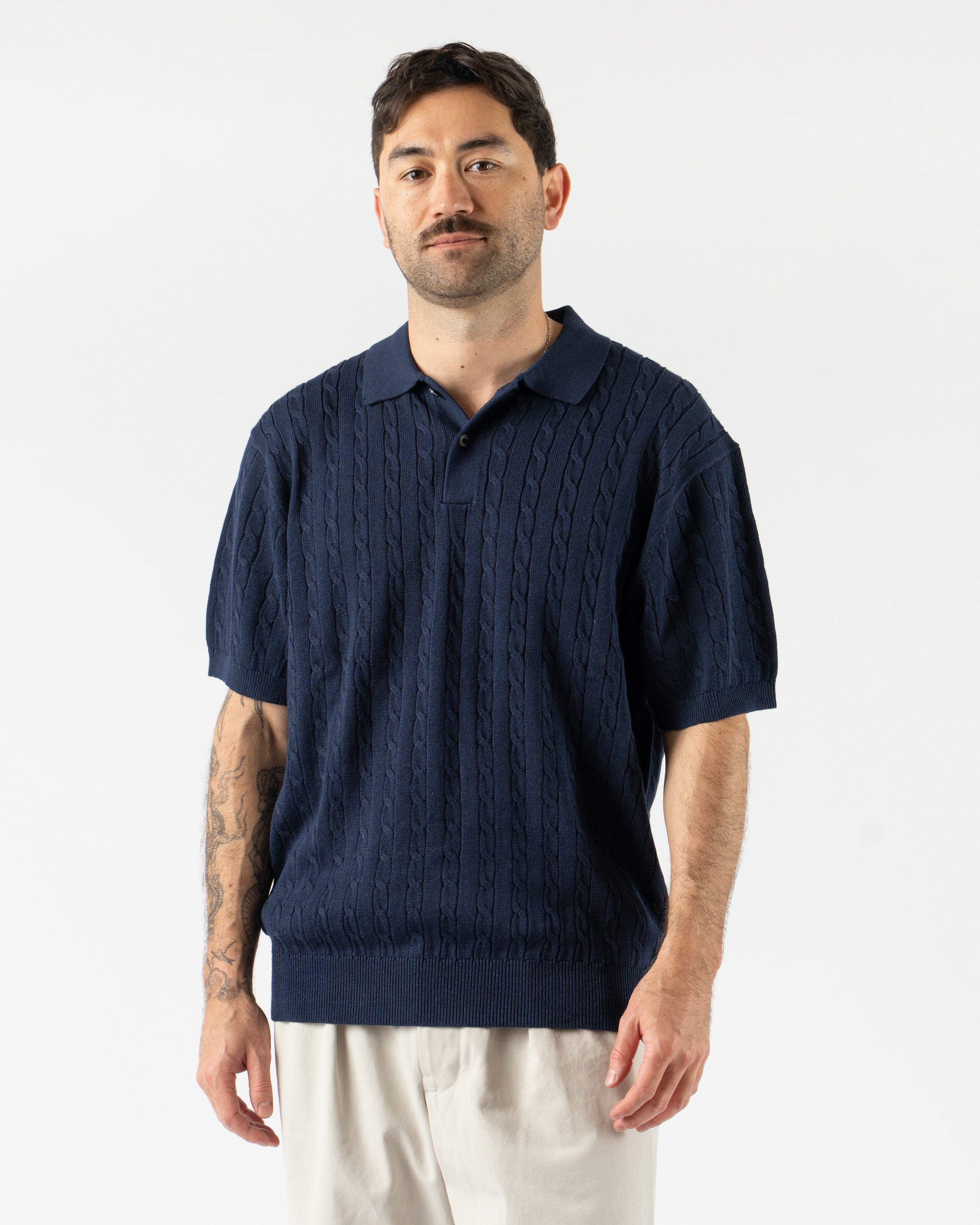 Beams Plus Cable Knit Polo in Navy – timeless men’s short sleeve polo with a textured cable knit pattern, crafted from soft cotton with a ribbed collar and tonal buttons for a refined, vintage-inspired style.