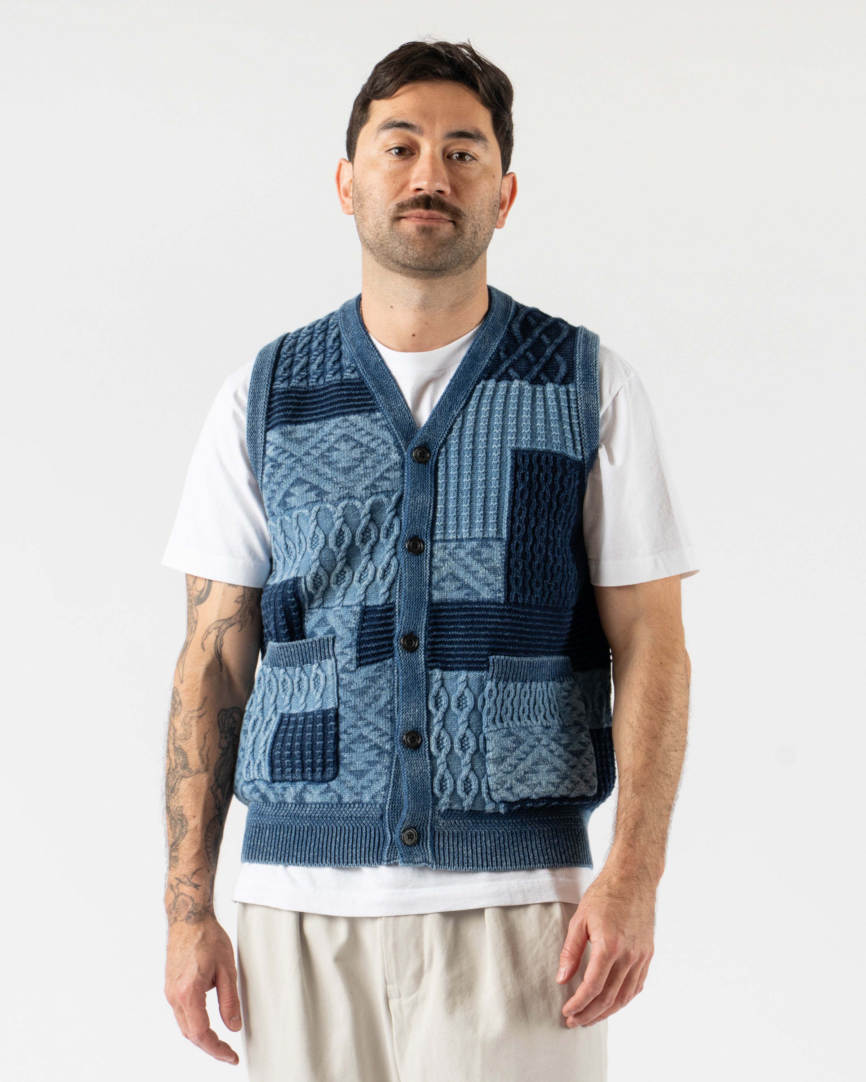 Beams Plus Patchwork Indigo Vest – heritage-inspired men’s vest crafted from a mix of indigo-dyed fabrics in a patchwork design, featuring a button-front closure, V-neckline, and multiple front pockets for a rugged, utilitarian look.