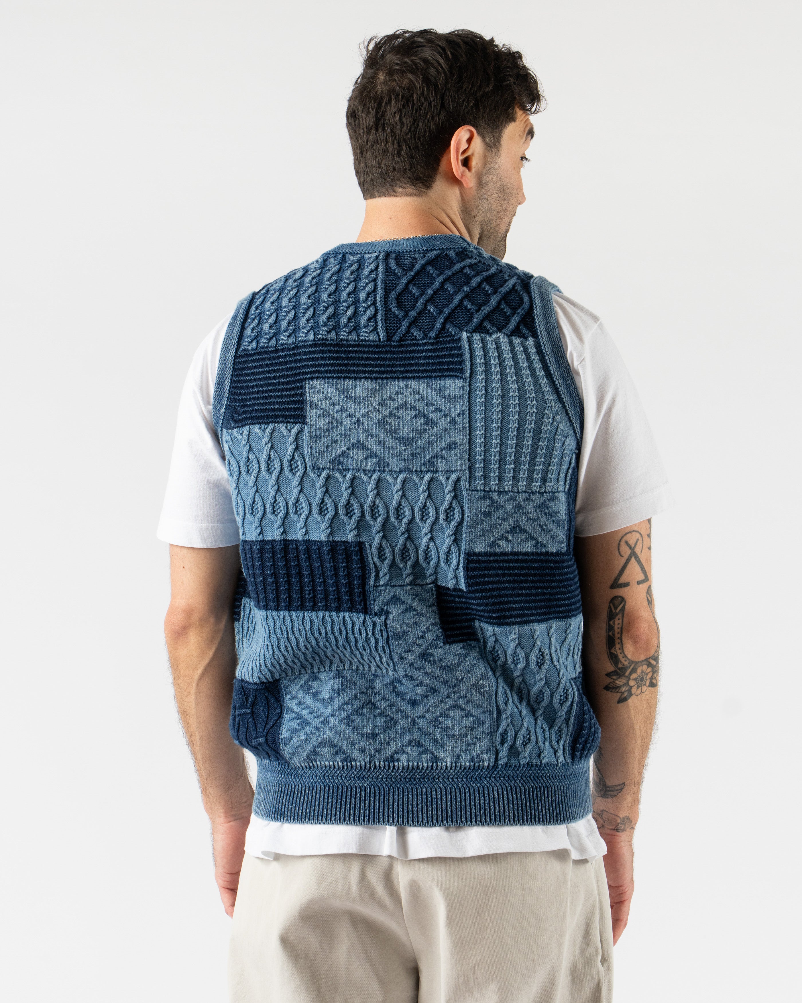 Beams Plus Patchwork Indigo Vest – heritage-inspired men’s vest crafted from a mix of indigo-dyed fabrics in a patchwork design, featuring a button-front closure, V-neckline, and multiple front pockets for a rugged, utilitarian look.