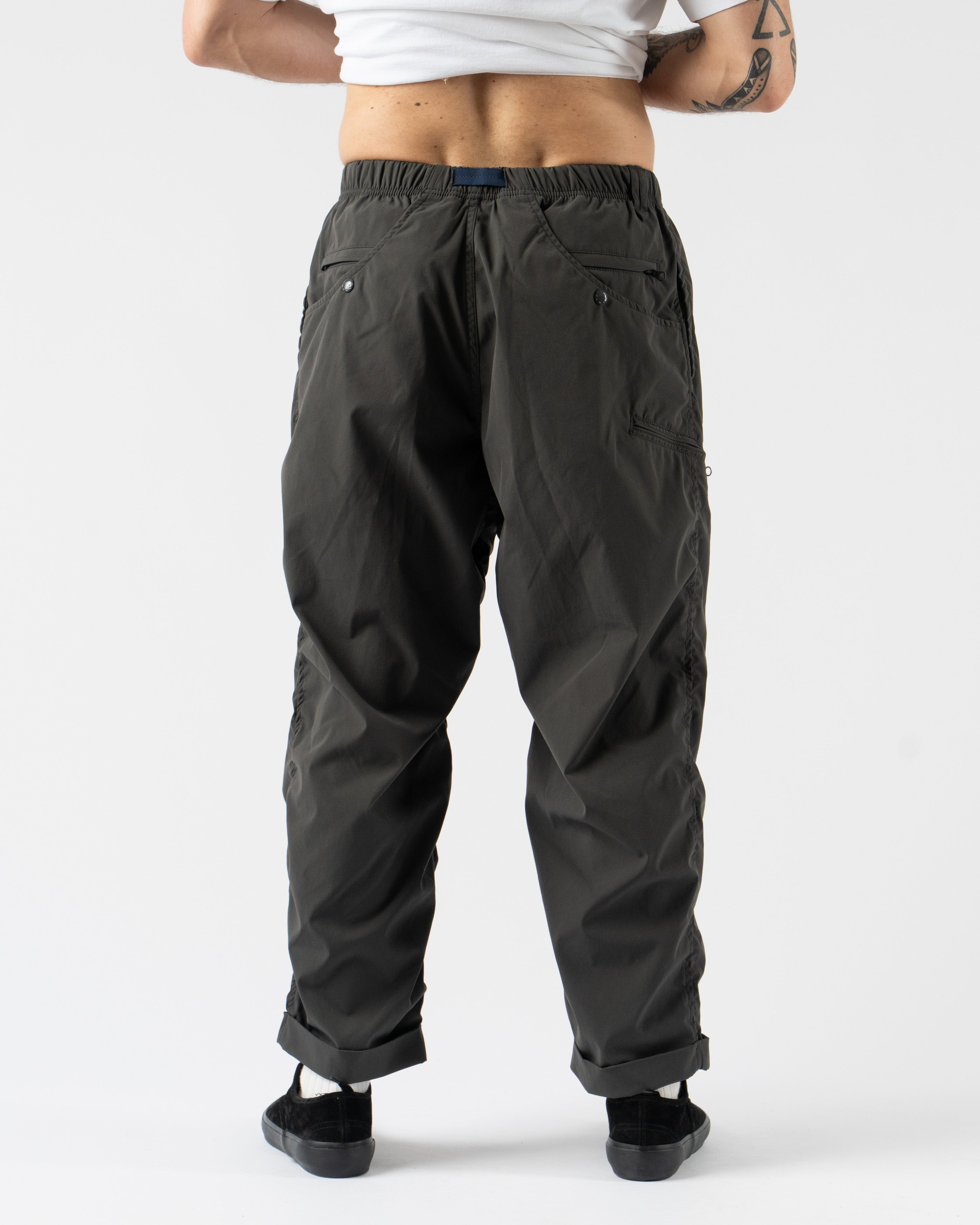 Pilgrim Surf + Supply Salathe Climbing Pant in Charcoal shown from multiple angles, crafted from recycled polyester with a relaxed, tapered fit, elastic waistband, and articulated knees. Featuring durable construction, minimal branding, and technical design details ideal for climbing, travel, or everyday wear in a versatile charcoal grey.
