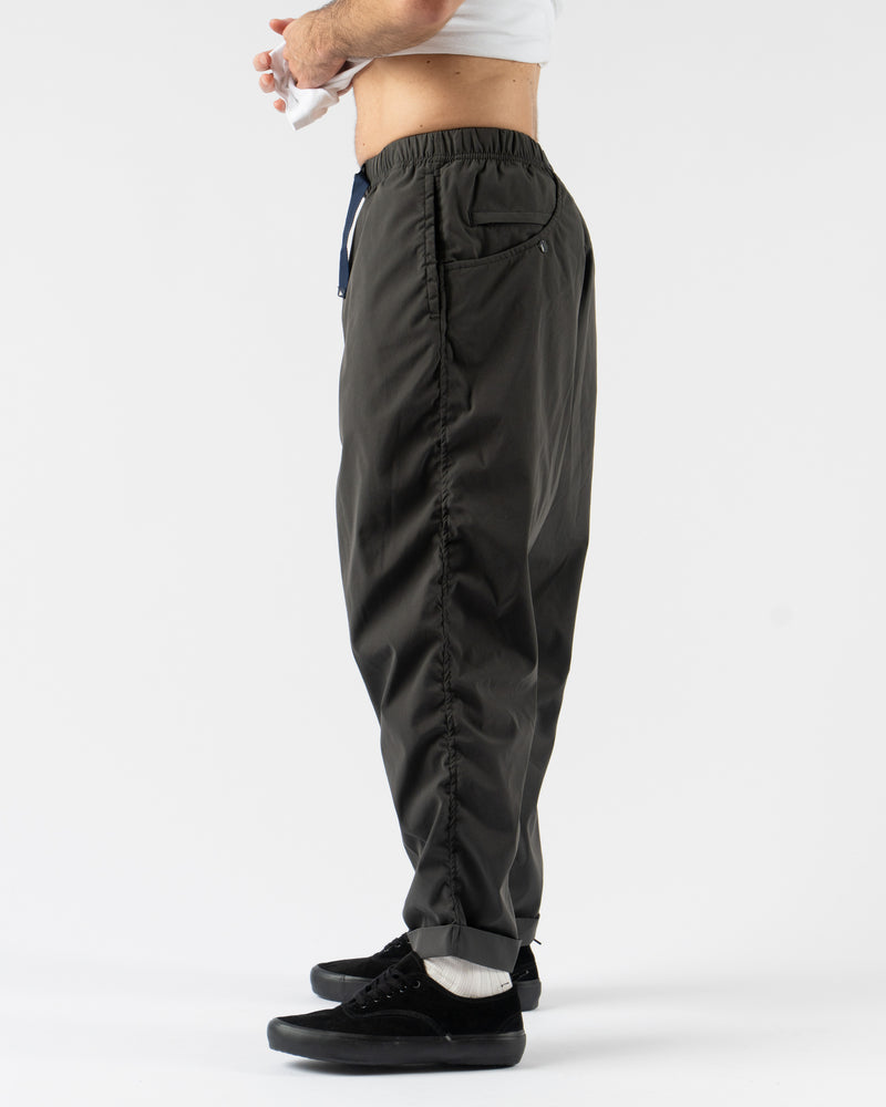 Pilgrim Surf + Supply Salathe Climbing Pant in Charcoal shown from multiple angles, crafted from recycled polyester with a relaxed, tapered fit, elastic waistband, and articulated knees. Featuring durable construction, minimal branding, and technical design details ideal for climbing, travel, or everyday wear in a versatile charcoal grey.