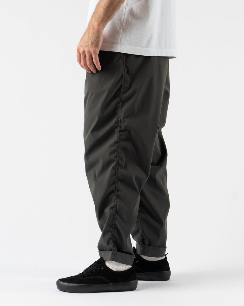 Pilgrim Surf + Supply Salathe Climbing Pant in Charcoal shown from multiple angles, crafted from recycled polyester with a relaxed, tapered fit, elastic waistband, and articulated knees. Featuring durable construction, minimal branding, and technical design details ideal for climbing, travel, or everyday wear in a versatile charcoal grey.