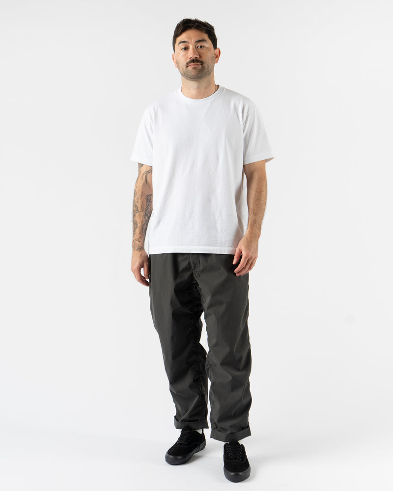 Pilgrim Surf + Supply Salathe Climbing Pant in Charcoal shown from multiple angles, crafted from recycled polyester with a relaxed, tapered fit, elastic waistband, and articulated knees. Featuring durable construction, minimal branding, and technical design details ideal for climbing, travel, or everyday wear in a versatile charcoal grey.