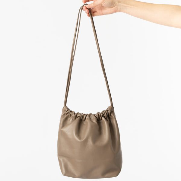 Modern Weaving Lamb Gather Bucket Bag in Earth Curated at Jake and