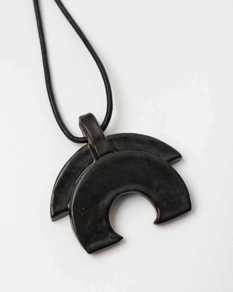 jeanne-ceramics-black-half-moon-necklace-on-black-leather-jake-and-jones-a-santa-barbara-boutique